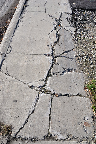 A sidewalk in front of one of our client's home before we gave it a repair. It's definitely not safe to have concrete get to this state.