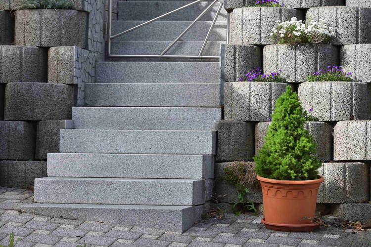 Decorative concrete was used when installing the stairs for one of our North Coquitlam clients. On top of the stairs, we added a makeshift retaining wall with circular concrete blocks.